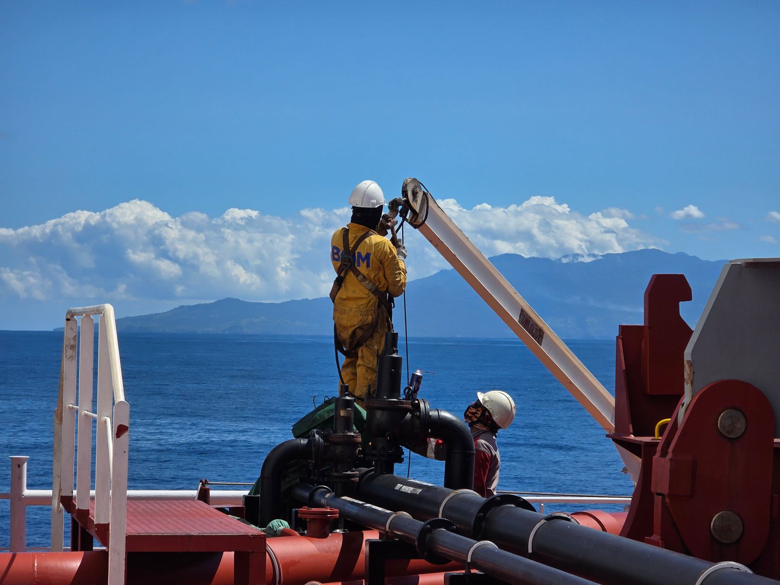 Offshore oil and gas workers on a platform deck during operations